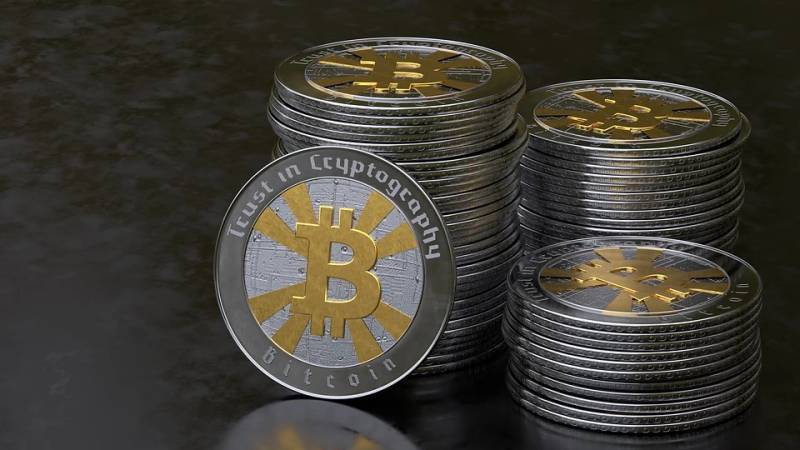 Stack of physical Bitcoin cryptocurrency tokens representing digital asset collateral