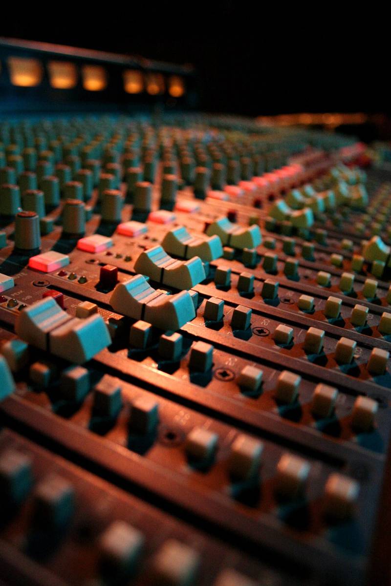 Professional audio studio mixing console channels reflecting real-time acoustic speech processing in Grok Voice 3.0