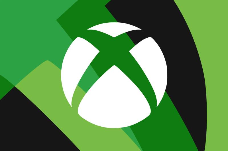 Microsoft Xbox console and wireless gaming controller sitting on clean studio display surface.