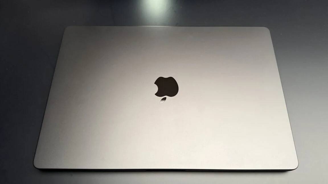 Exterior view of 16-inch MacBook Pro closed unibody chassis on a testing bench.