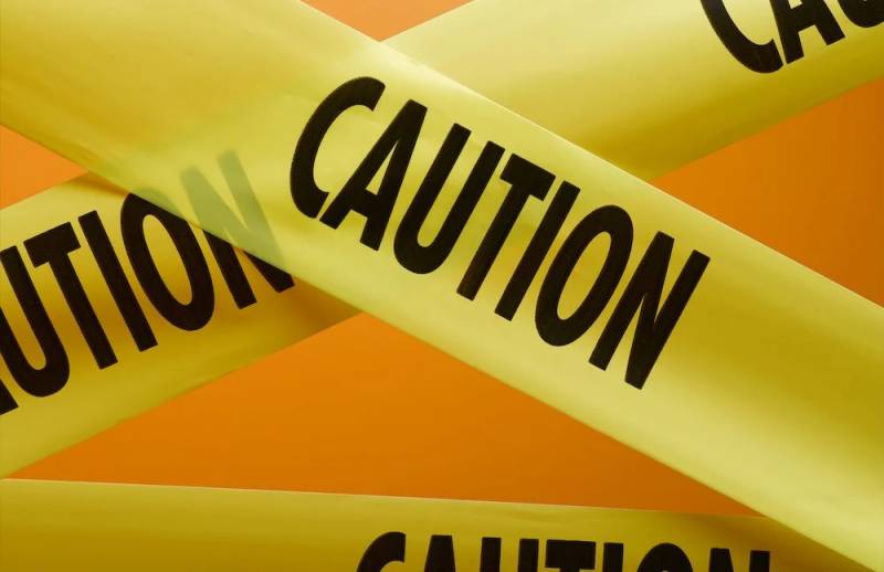 Caution security perimeter tape symbolizing cyber defense and vulnerability response.