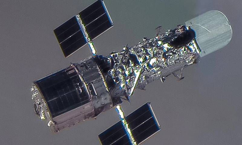 Hubble Space Telescope with solar arrays deployed in low Earth orbit.